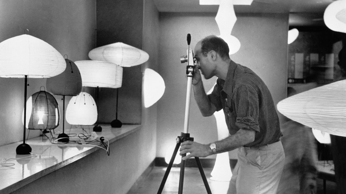 Isamu Noguchi photographing “Isamu Noguchi Exhibition,” Chuo Koron Gallery, Tokyo, August 2–7, 1954. The Noguchi Museum Archives, 07020. ©INFGM / ARS