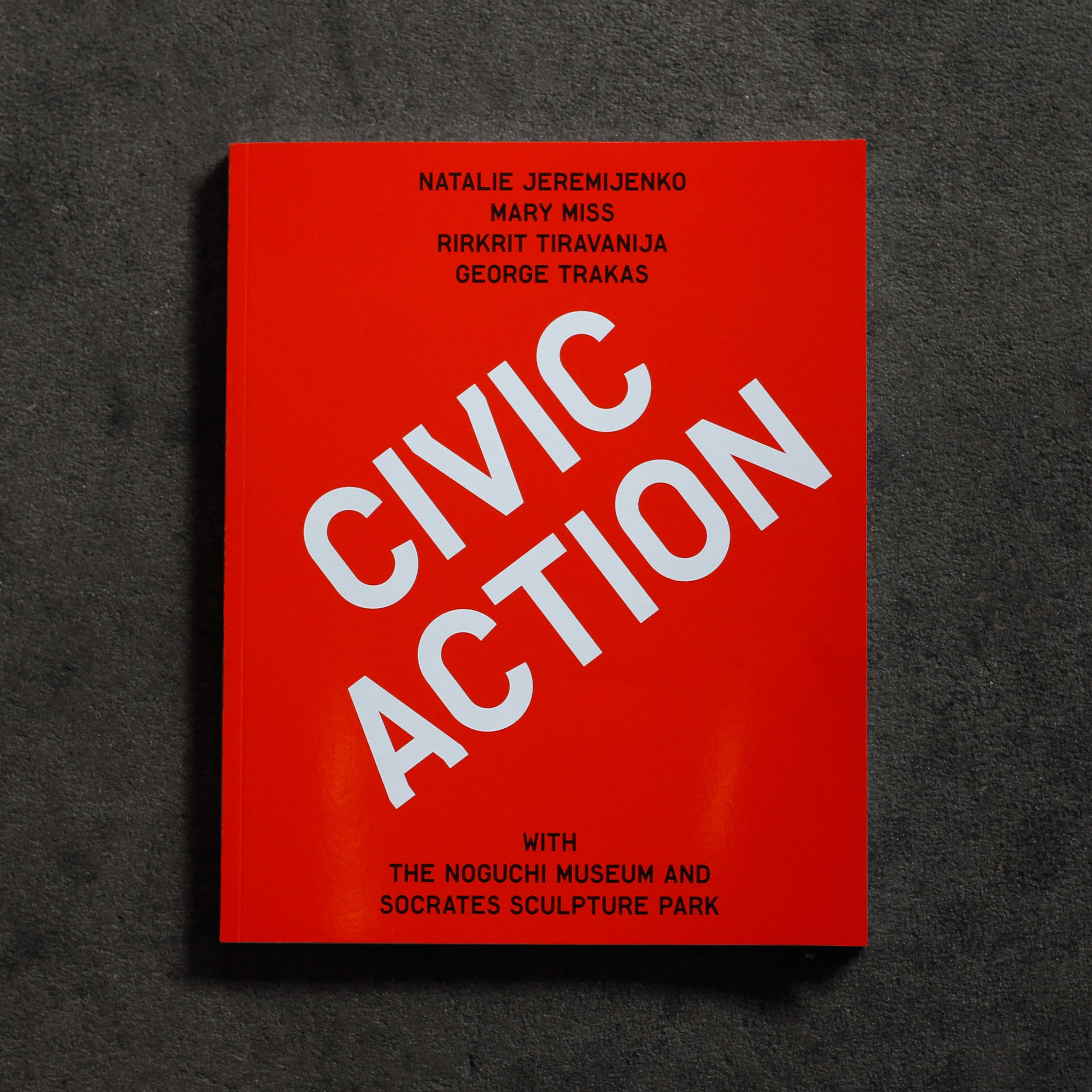 Cover of 'Civic Action,' a bright red-orange solid cover with large diagonal headline 'Civic Action' in white sans serif type, 'Natalie Jeremijenko, Mary Miss, Rikrit Tiravanija, George Trakas' in smaller centered black sans serif type at top and 'with The Noguchi Museum and Socrates Sculpture Park' in same black centered type at bottom